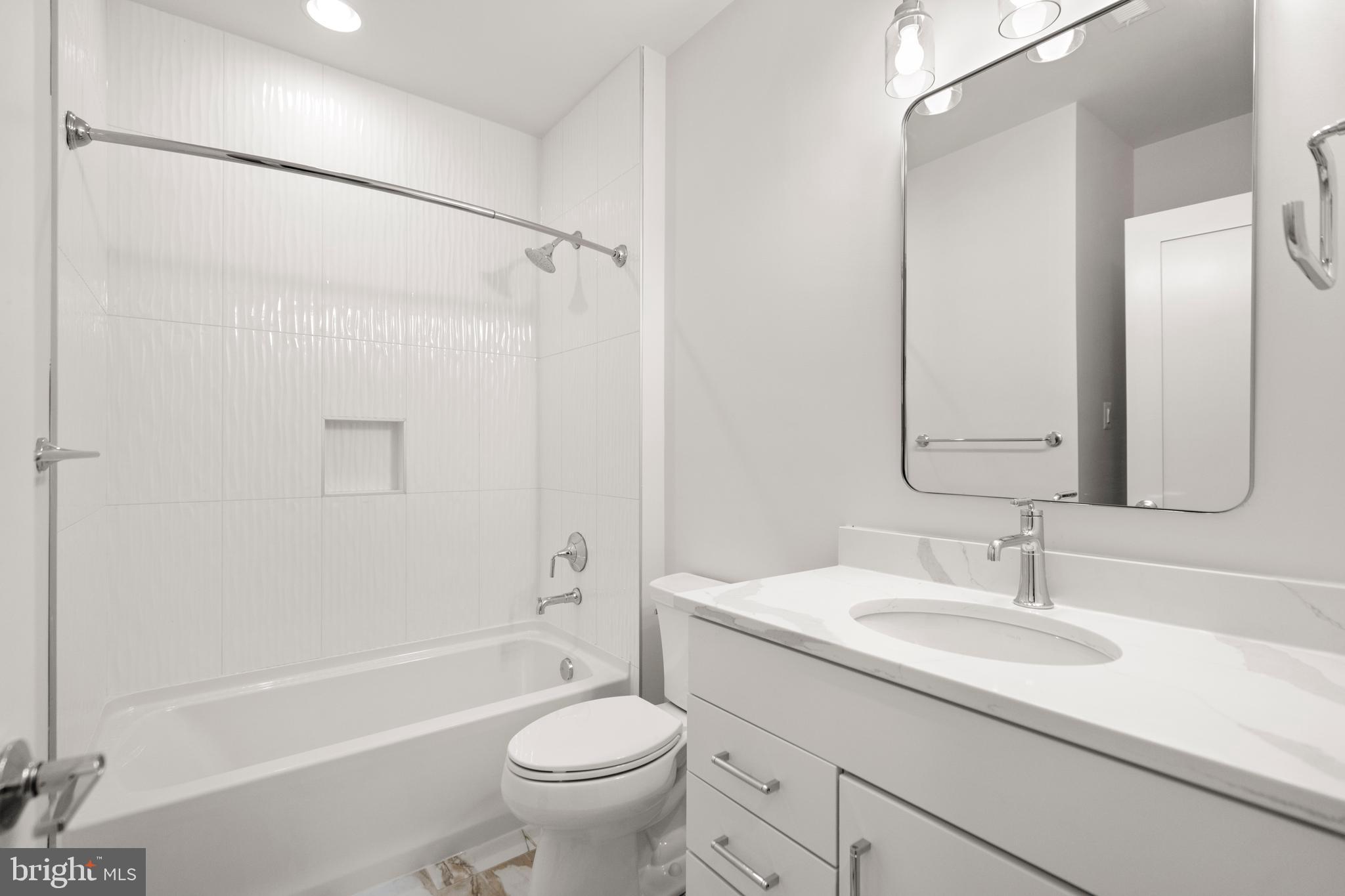 8506 Hempstead Avenue Bethesda, MD 20817 - Photo 52 of 57 a bathroom with a sink a mirror toilet and bathtub