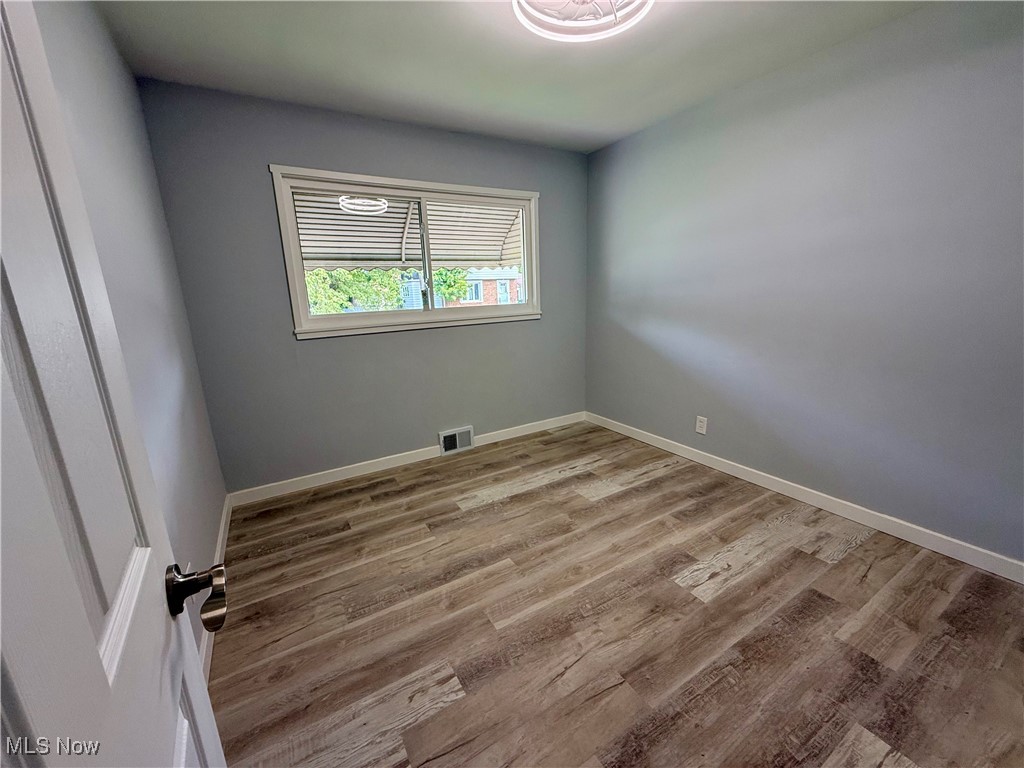 19504 Sumpter Road Cleveland, OH 44128 - Photo 17 of 39 Unfurnished room with light wood-style flooring and baseboards