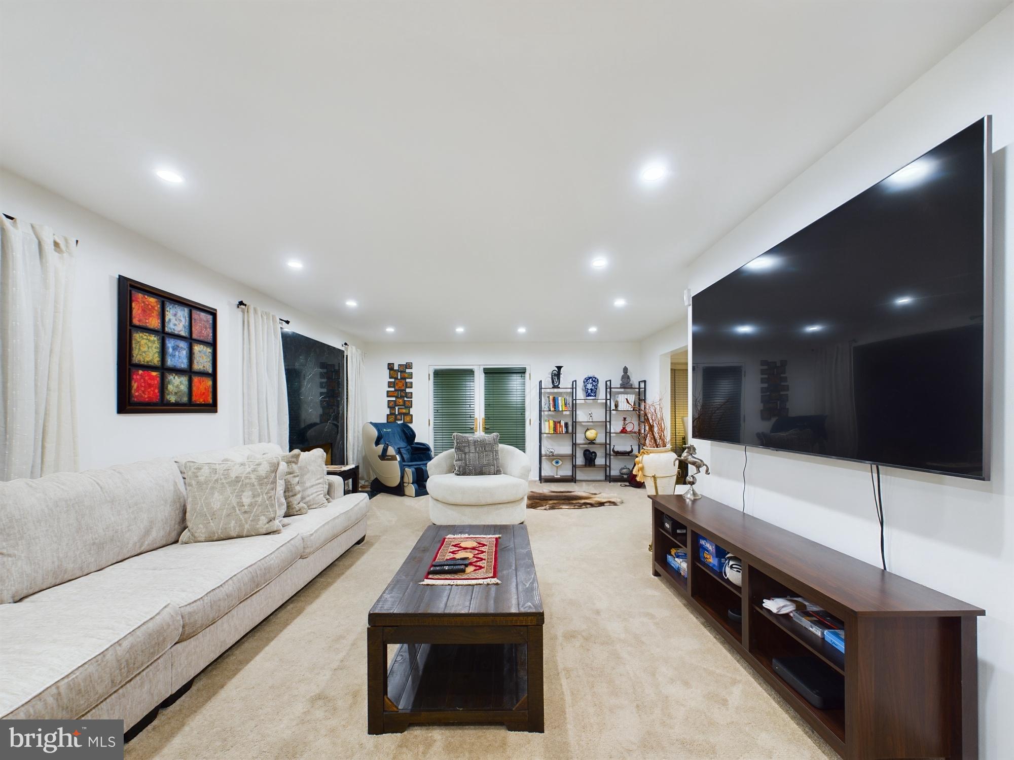 2906 Cedar Lane Vienna, VA 22180 - Photo 11 of 18 a living room with furniture and a flat screen tv