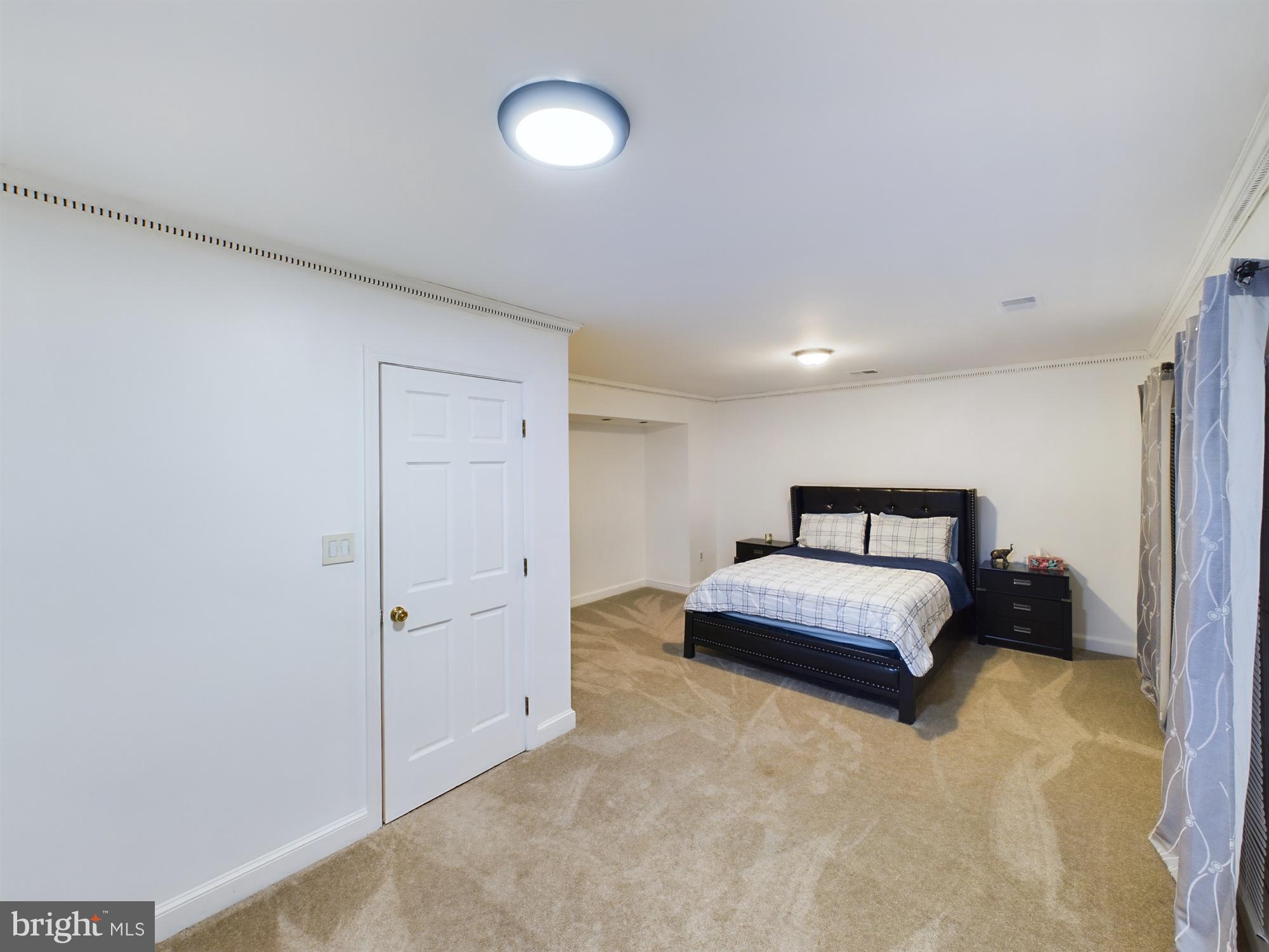 2906 Cedar Lane Vienna, VA 22180 - Photo 14 of 18 a spacious bedroom with a bed and a cabinets