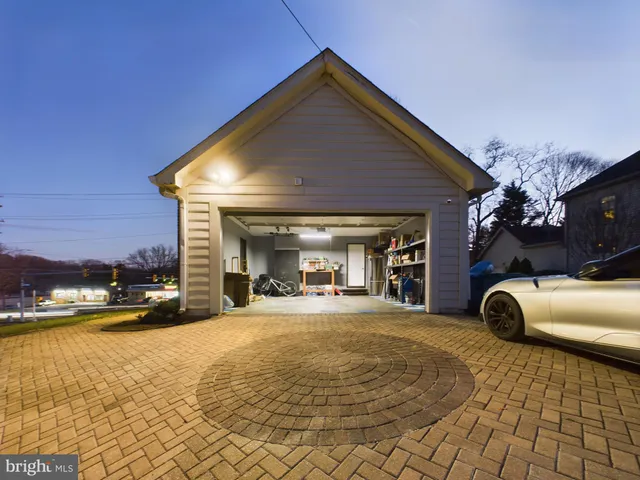 a view of a house with barbeque and sitting area