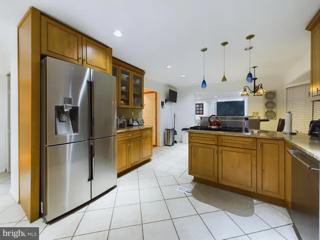 a kitchen with cabinets and stainless steel appliances
