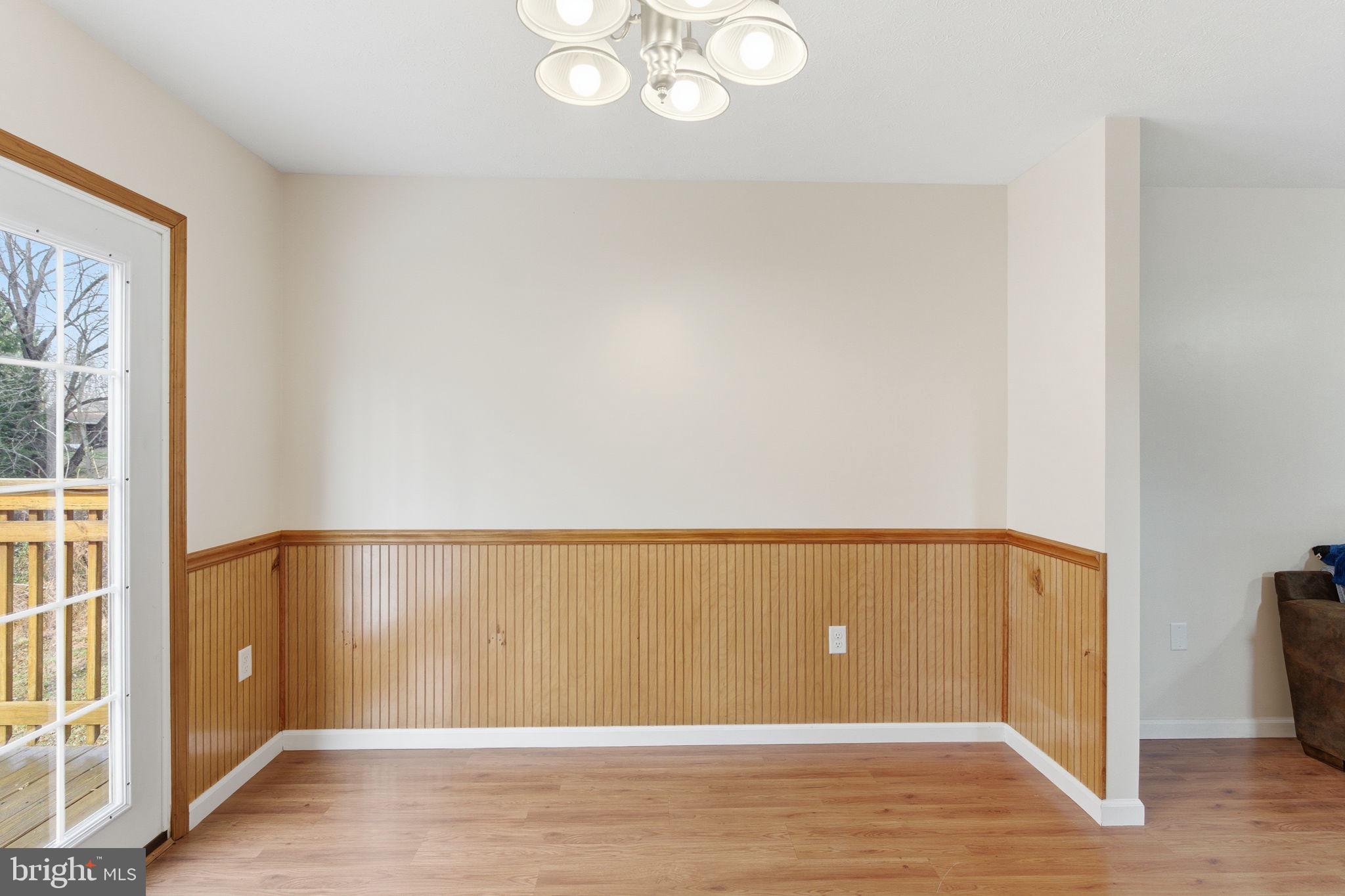 148 Vinca Lane Falling Waters, WV 25419 - Photo 12 of 71 a view of an empty room with wooden floor and a window