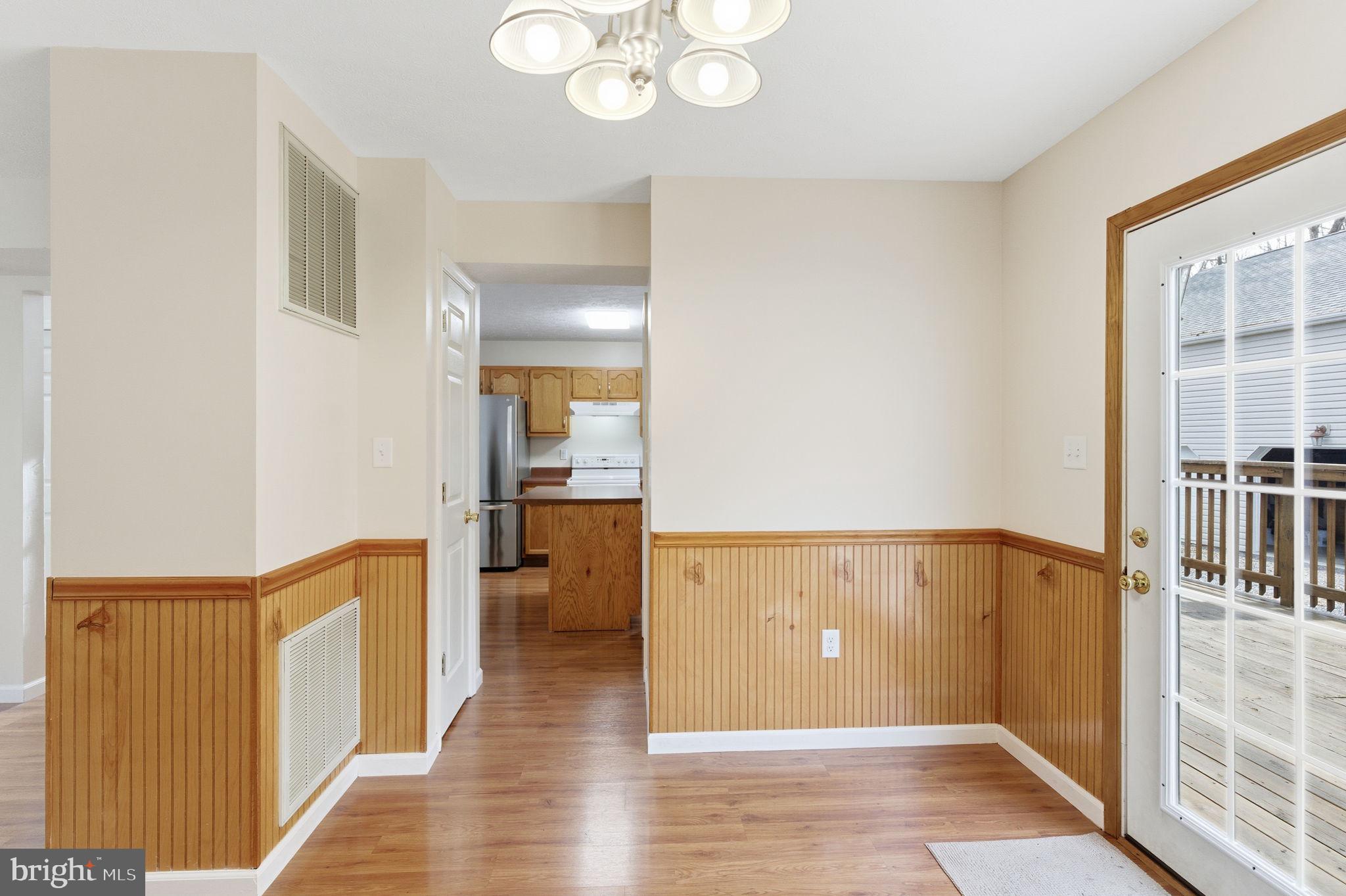 148 Vinca Lane Falling Waters, WV 25419 - Photo 13 of 71 a view of a hallway with wooden floor and staircase