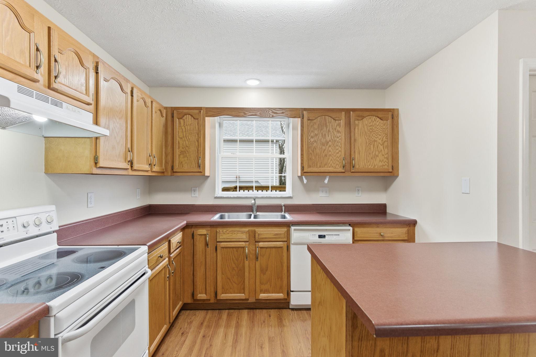 148 Vinca Lane Falling Waters, WV 25419 - Photo 15 of 71 a kitchen with stainless steel appliances granite countertop a sink a stove and cabinets