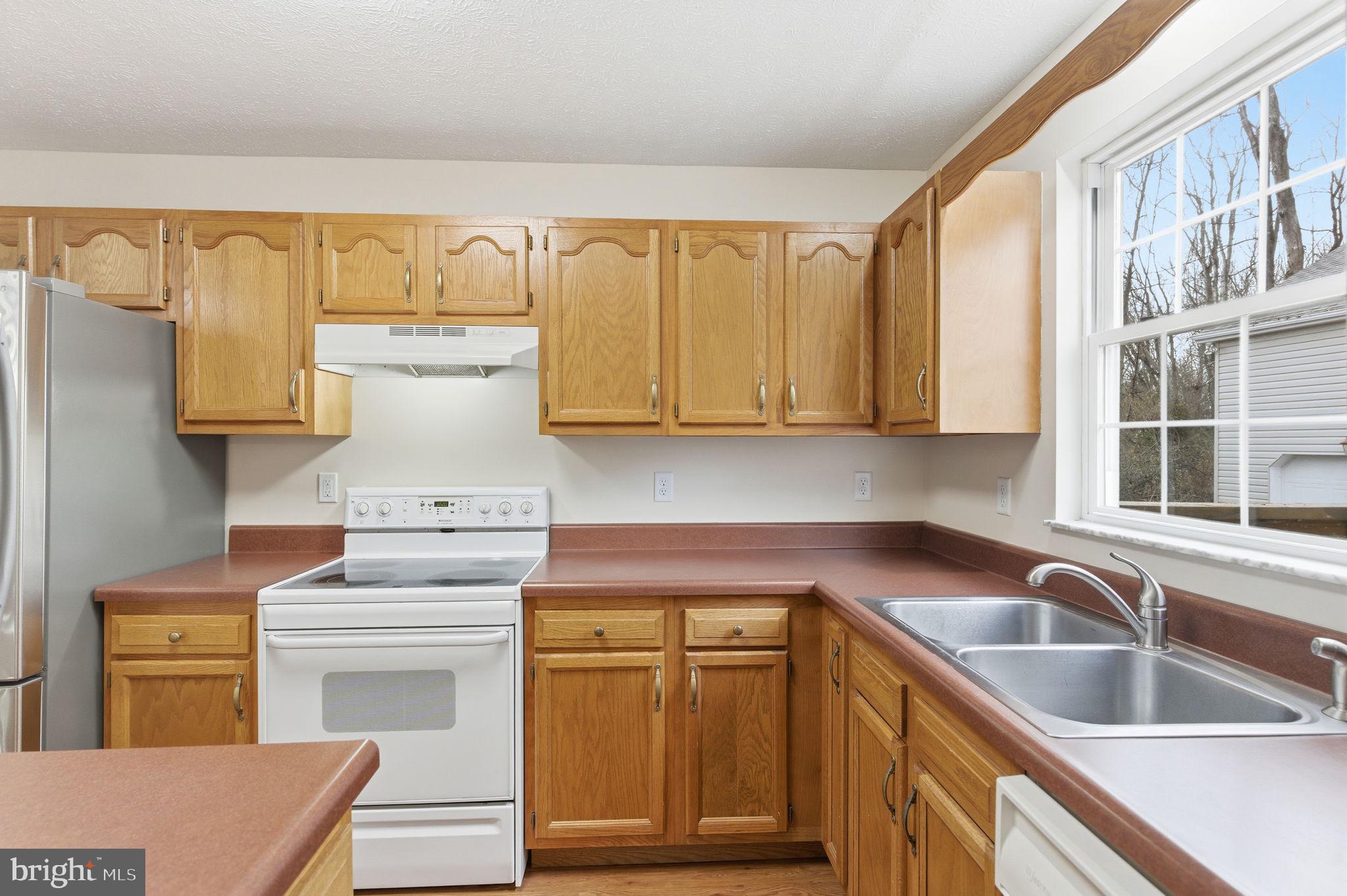 148 Vinca Lane Falling Waters, WV 25419 - Photo 16 of 71 a kitchen with a sink stove and cabinets