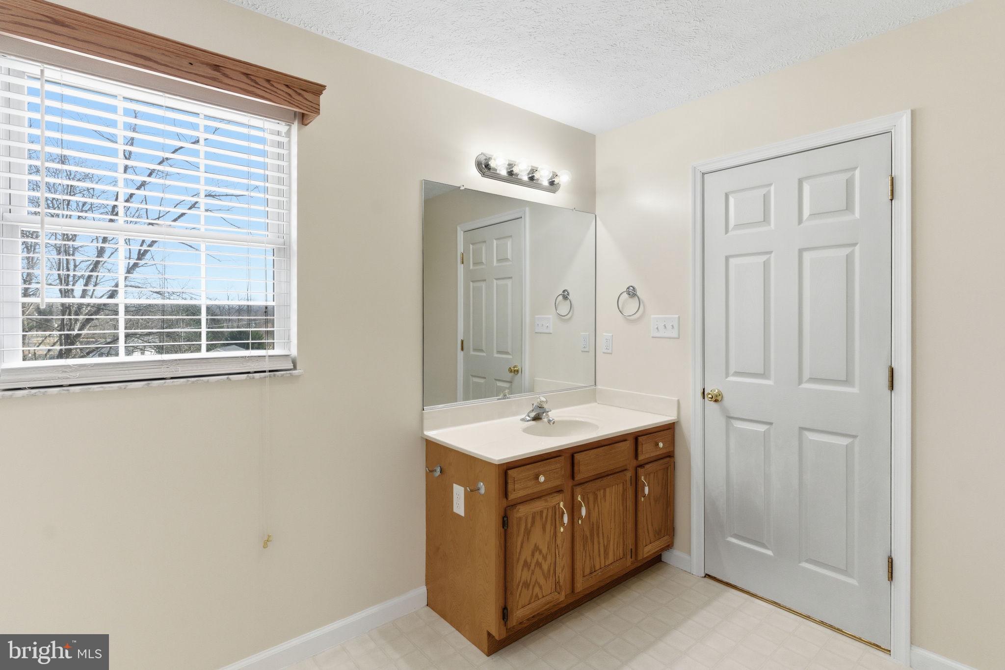 148 Vinca Lane Falling Waters, WV 25419 - Photo 27 of 71 a spacious bathroom with a double vanity sink a mirror and a shower