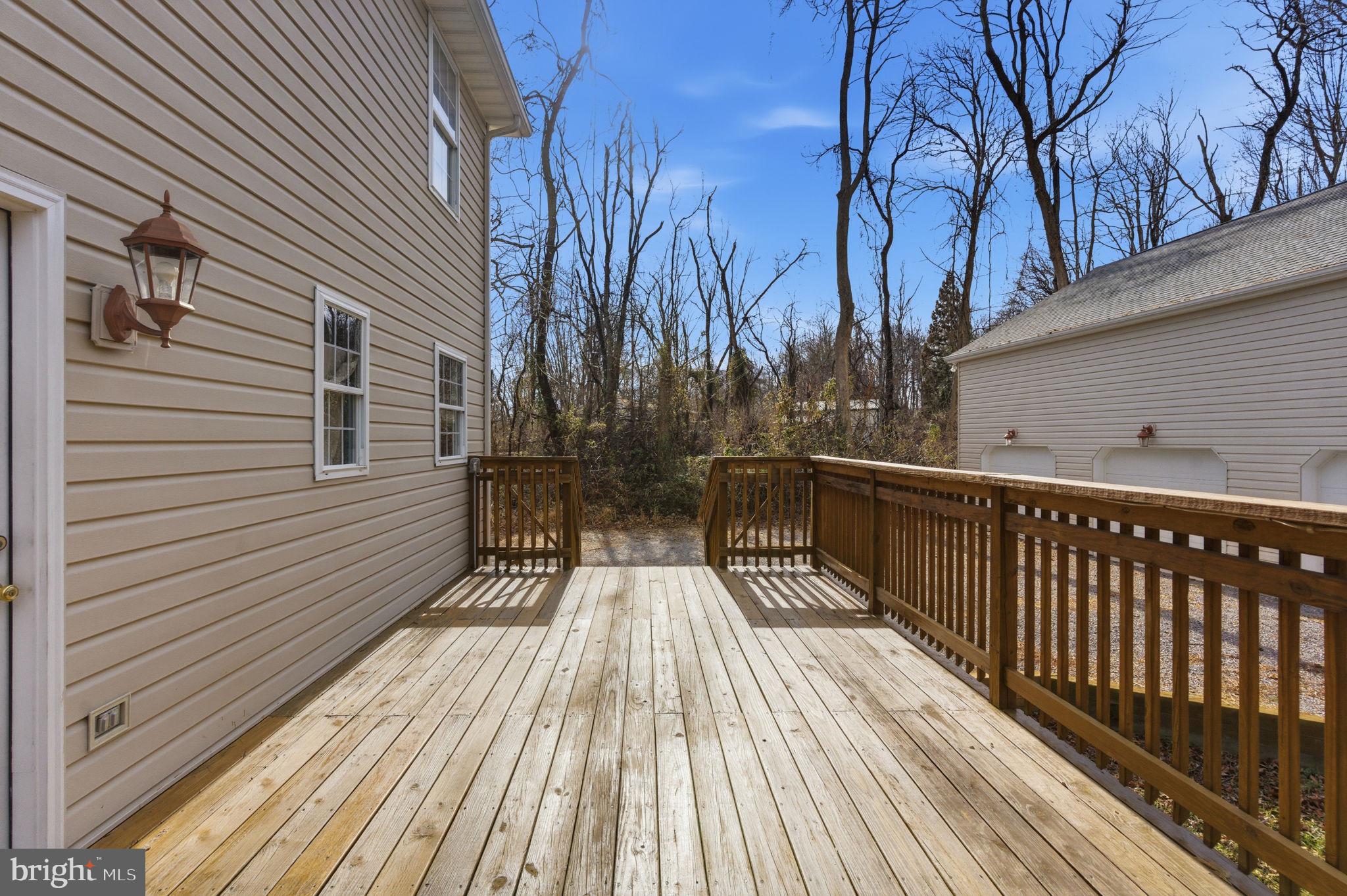 148 Vinca Lane Falling Waters, WV 25419 - Photo 42 of 71 a view of balcony with wooden floor and fence and floor to ceiling window