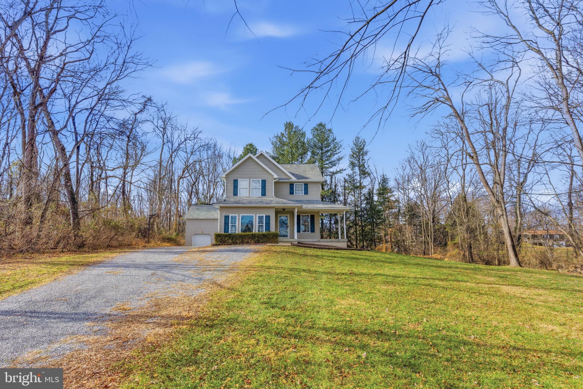 148 Vinca Lane Falling Waters, WV 25419 - Photo 62 of 71 a front view of a house with a yard