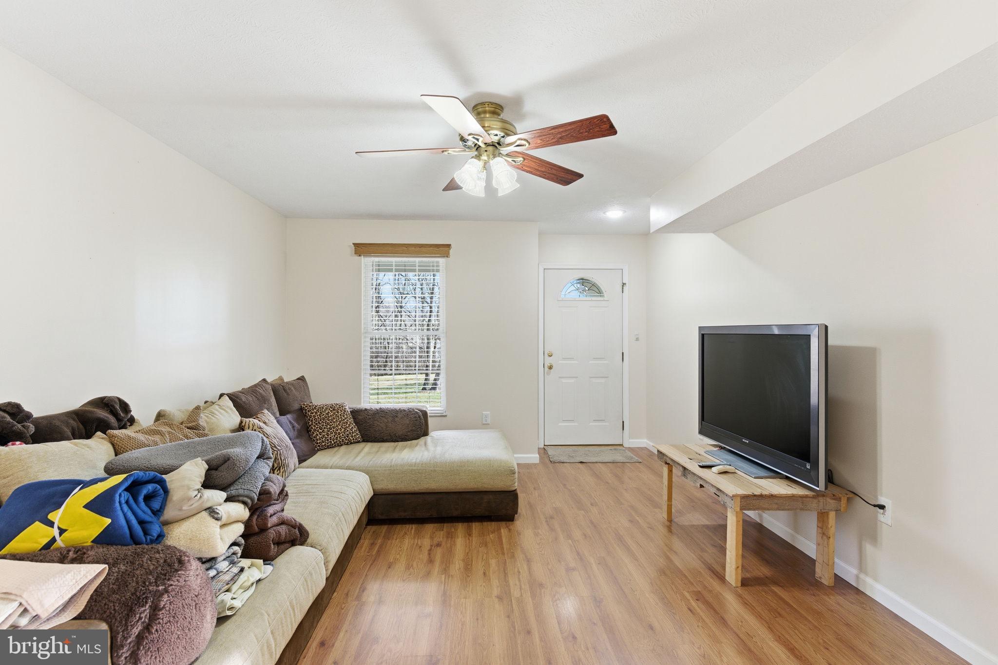 148 Vinca Lane Falling Waters, WV 25419 - Photo 10 of 71 a living room with furniture and a flat screen tv