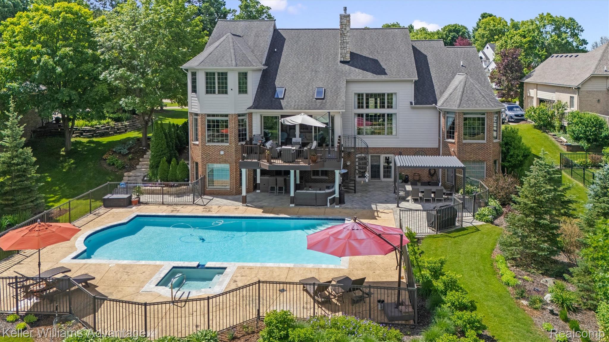 22878 Tree Top Court South Lyon, MI 48178 - Photo 46 of 75 Stately residence featuring a multi-level deck, expansive patio with pergola, and a large inground pool with integrated spa
