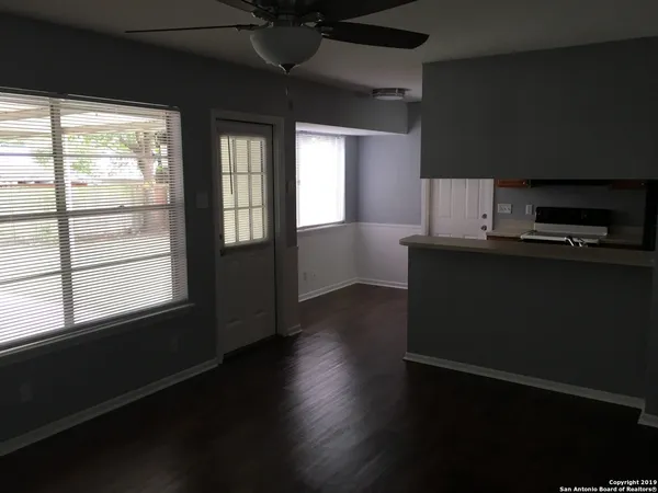 a kitchen with kitchen island wooden floors and a black appliances