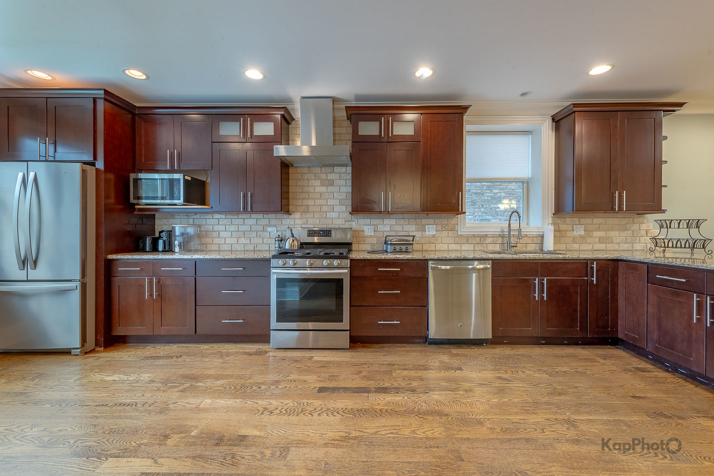 3639 North Troy Street, Unit 2 Chicago, IL 60618 - Photo 10 of 30 a kitchen with stainless steel appliances granite countertop a stove a sink dishwasher a refrigerator and a oven