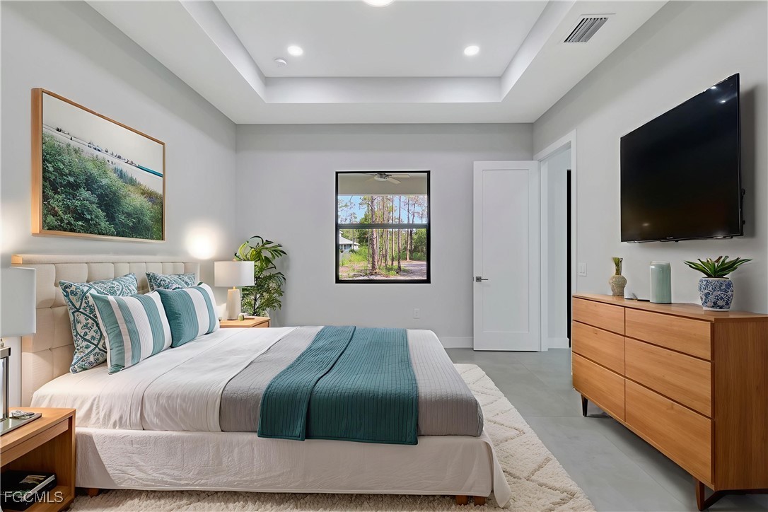 3366 72nd Avenue Northeast Naples, FL 34120 - Photo 12 of 49 a bedroom with a bed and a flat screen television