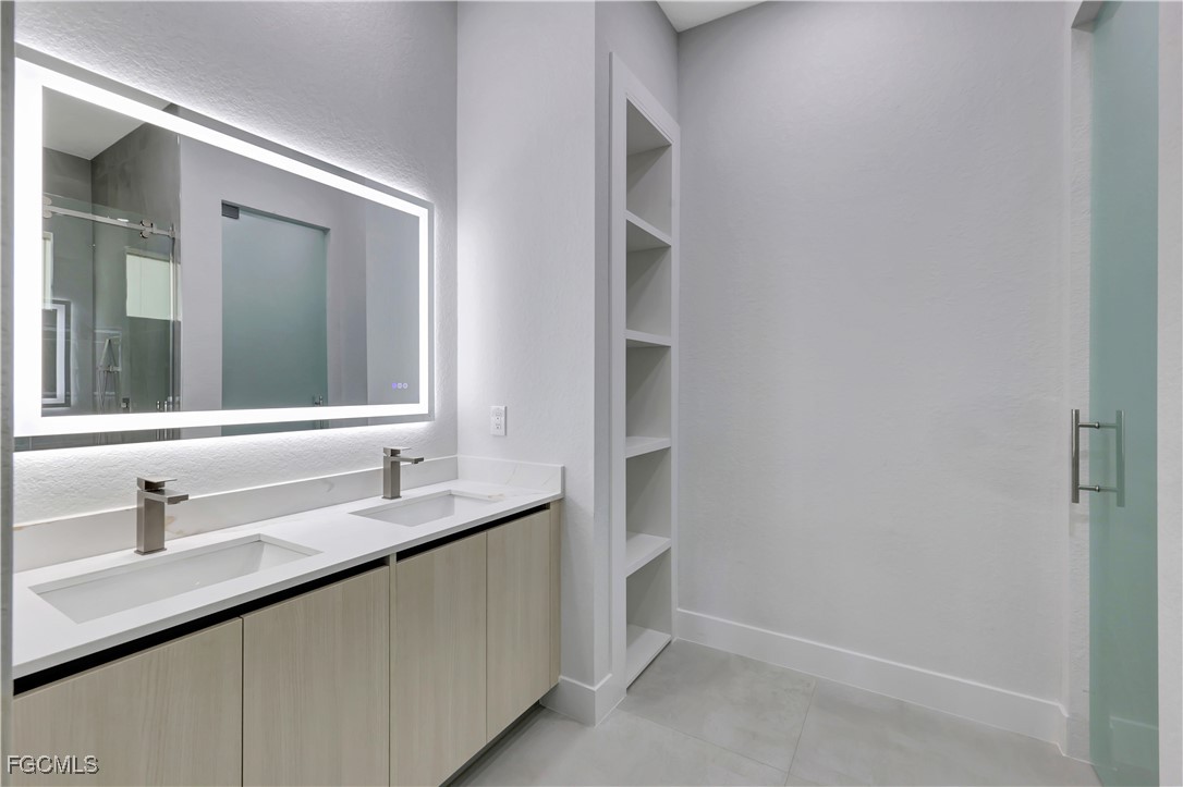 3366 72nd Avenue Northeast Naples, FL 34120 - Photo 17 of 49 a bathroom with a sink and a mirror