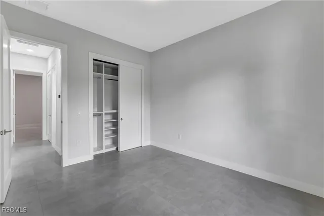 a bedroom with bed and a couch