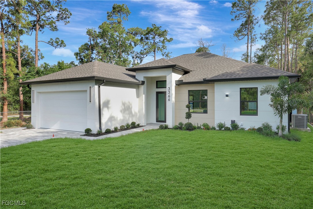 3366 72nd Avenue Northeast Naples, FL 34120 - Photo 2 of 49 a front view of a house with a yard