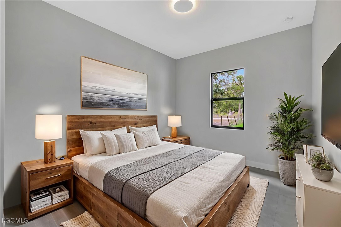 3366 72nd Avenue Northeast Naples, FL 34120 - Photo 22 of 49 a bedroom with a bed and a potted plant