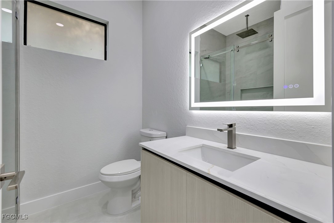 3366 72nd Avenue Northeast Naples, FL 34120 - Photo 24 of 49 a bathroom with a sink and a toilet