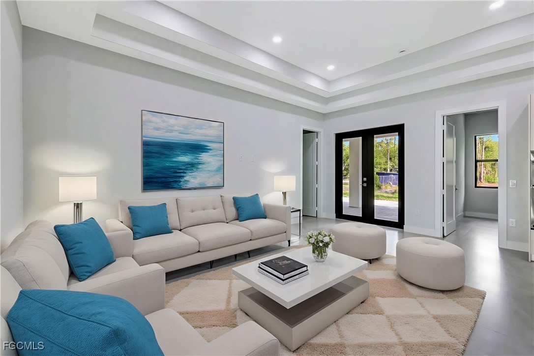 3366 72nd Avenue Northeast Naples, FL 34120 - Photo 26 of 49 a living room with furniture and a large window