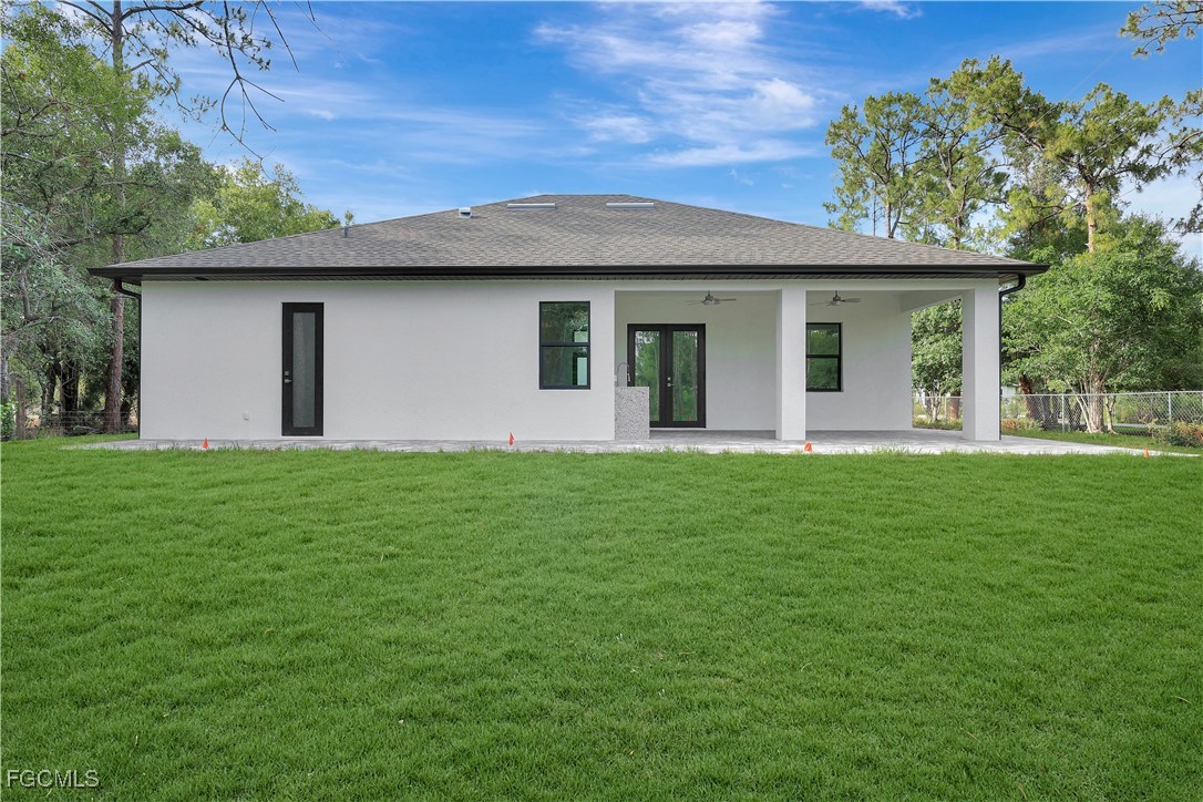 3366 72nd Avenue Northeast Naples, FL 34120 - Photo 38 of 49 a front view of a house with a garden