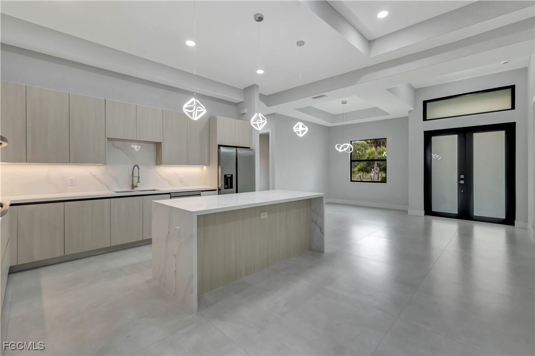 3366 72nd Avenue Northeast Naples, FL 34120 - Photo 4 of 49 a kitchen with stainless steel appliances granite countertop a refrigerator a sink dishwasher and a stove with wooden floors