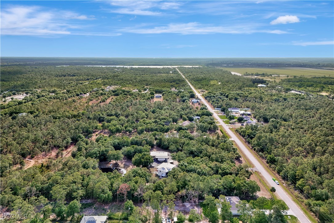3366 72nd Avenue Northeast Naples, FL 34120 - Photo 44 of 49 an aerial view of residential houses with outdoor space and trees