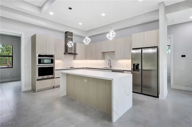 a kitchen with stainless steel appliances a refrigerator sink and stove