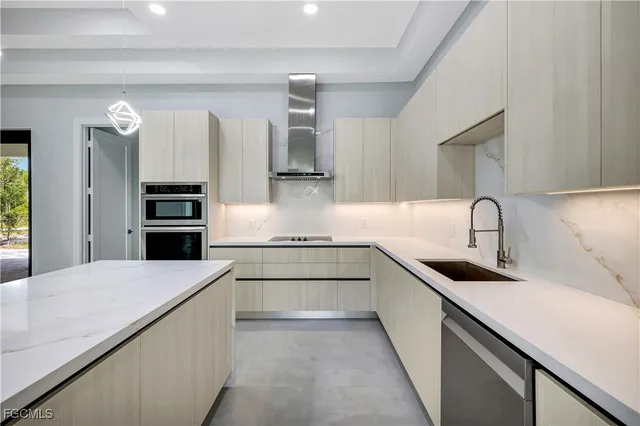 a kitchen with stainless steel appliances granite countertop a sink and white cabinets