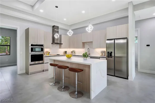 a kitchen with granite countertop a refrigerator stove top oven and sink