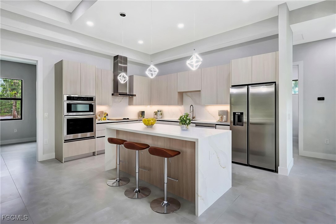 3366 72nd Avenue Northeast Naples, FL 34120 - Photo 7 of 49 a kitchen with granite countertop a refrigerator stove top oven and sink