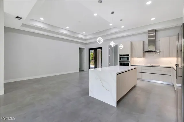 a large white building with kitchen area and a refrigerator