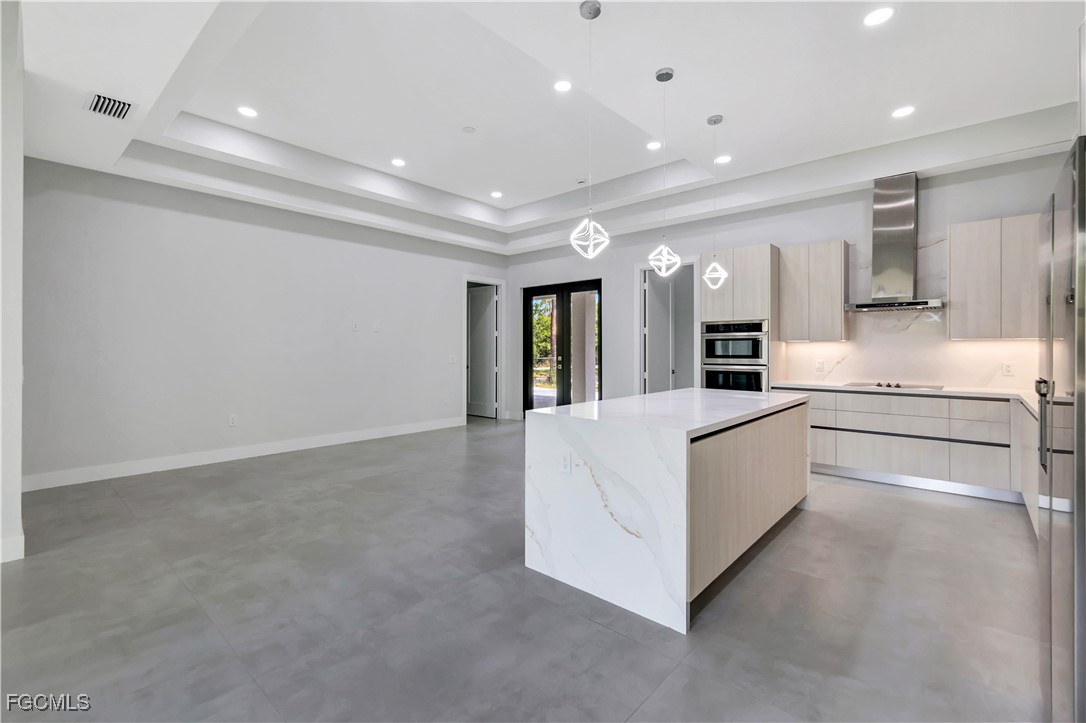 3366 72nd Avenue Northeast Naples, FL 34120 - Photo 9 of 49 a large white building with kitchen area and a refrigerator