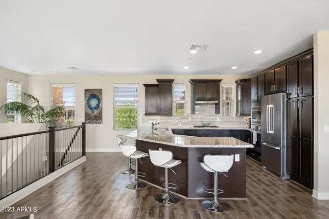 a view of a balcony with chairs and wooden floor