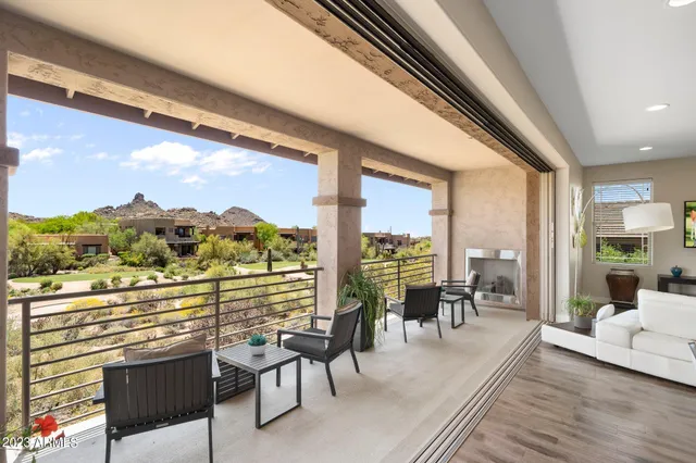 a bedroom with a bed and painting on the wall