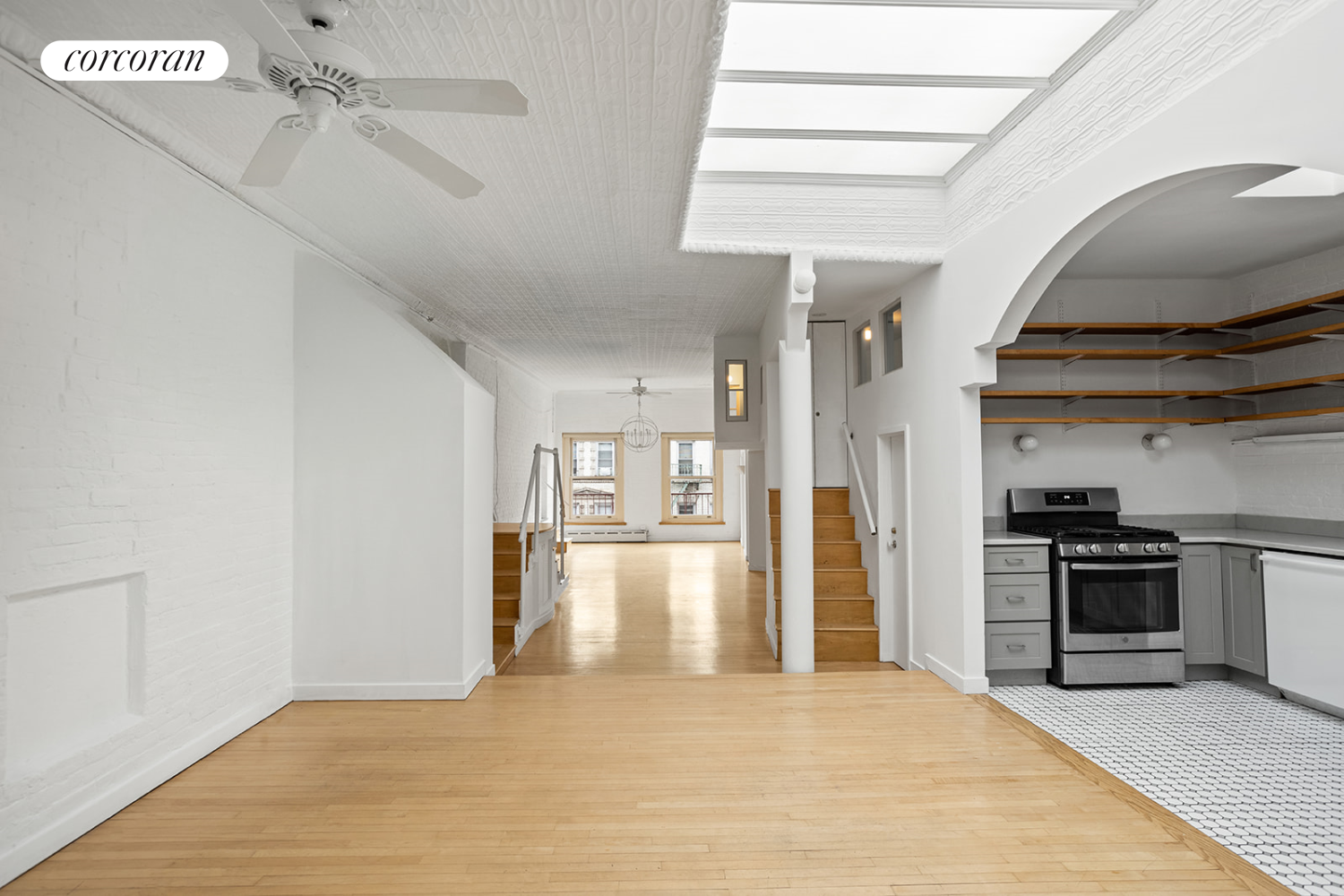 169 Spring Street, Unit 5W Manhattan, NY 10012 - Photo 5 of 20 a view of a kitchen with a stove cabinets and wooden floor