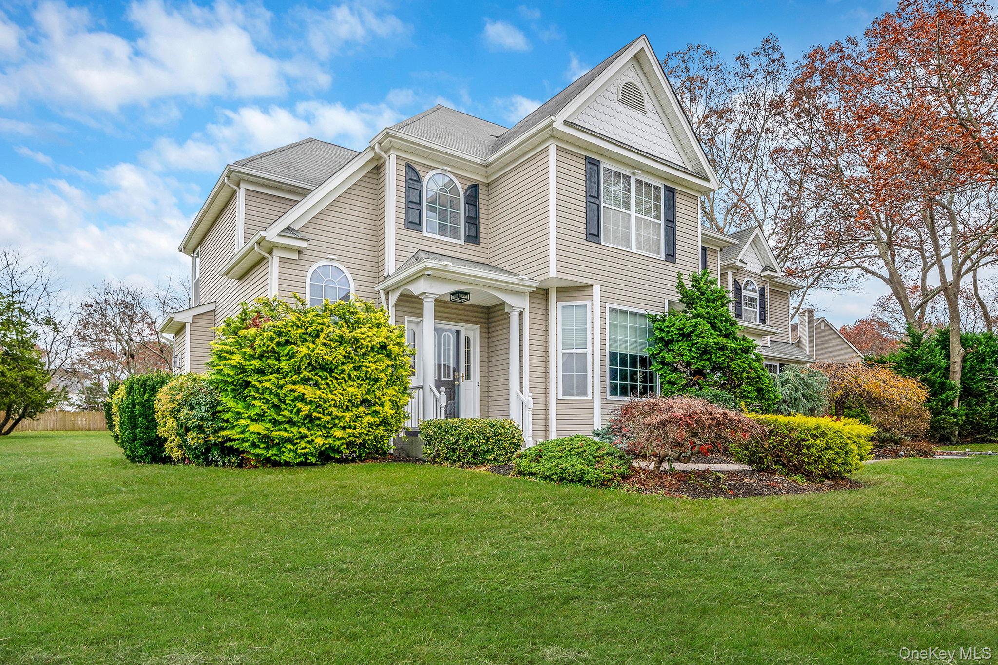 a front view of a house with a garden