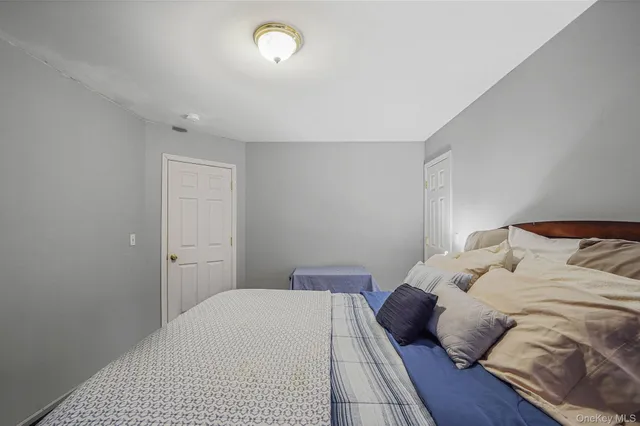 a bedroom with a bed and a night stand