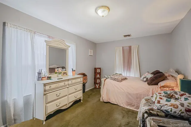 a bedroom with bed and a dresser