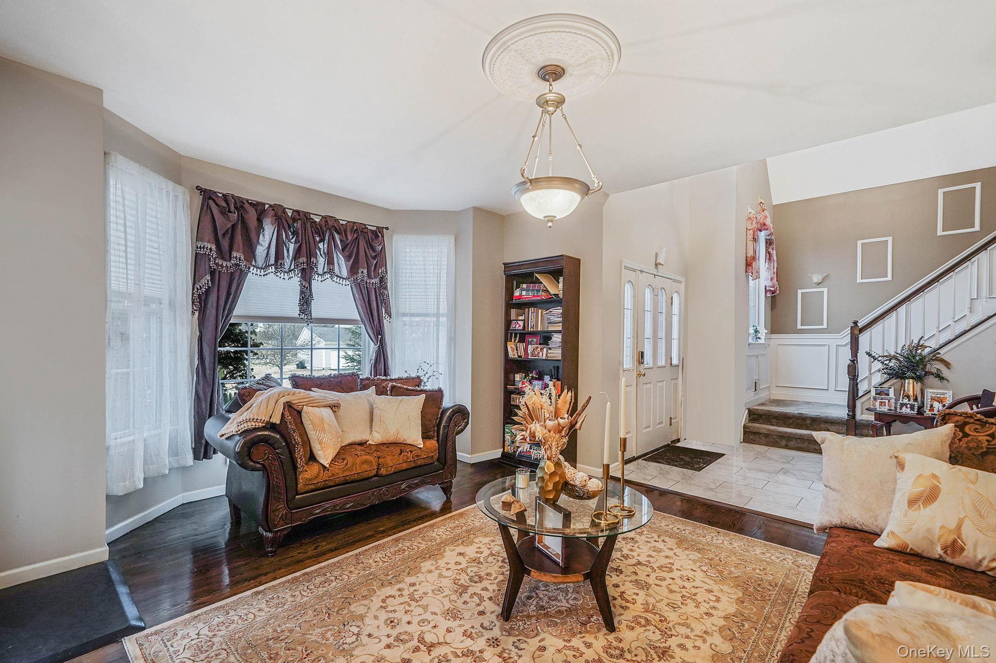 9 Paddock Lane Medford, NY 11763 - Photo 4 of 49 Living room featuring wood finished floors and stairs
