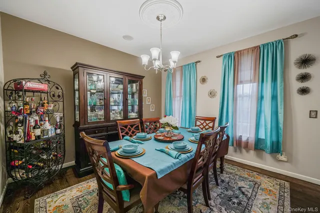 a view of a dining room with furniture and chandelier