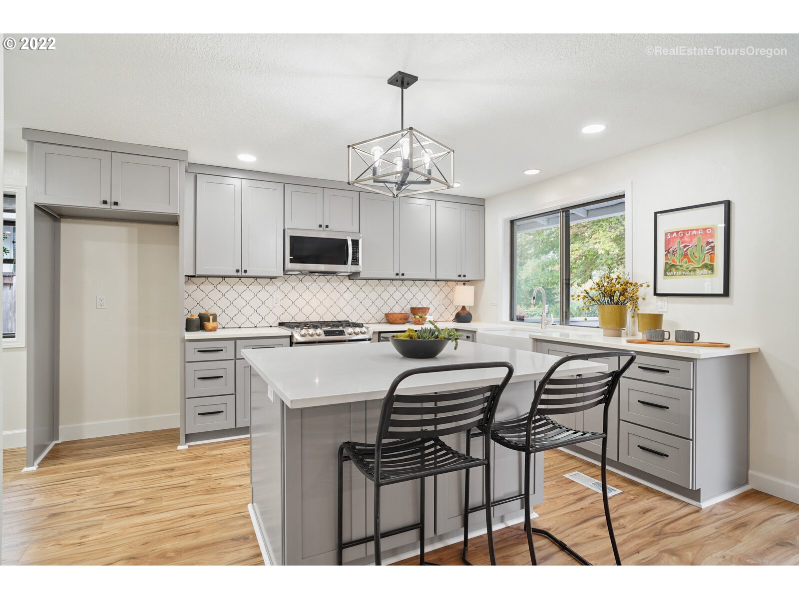 11280 Southwest Viewmount Court Tigard, OR 97223 - Photo 12 of 31 a kitchen with stainless steel appliances kitchen island granite countertop a refrigerator and microwave