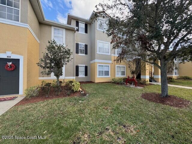 5692 Star Rush Drive, Unit 106 Melbourne, FL 32940 - Photo 1 of 16 a view of a house with a yard