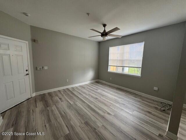 5692 Star Rush Drive, Unit 106 Melbourne, FL 32940 - Photo 11 of 16 a view of empty room with wooden floor and fan