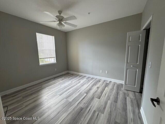 5692 Star Rush Drive, Unit 106 Melbourne, FL 32940 - Photo 12 of 16 wooden floor in an empty room with a window
