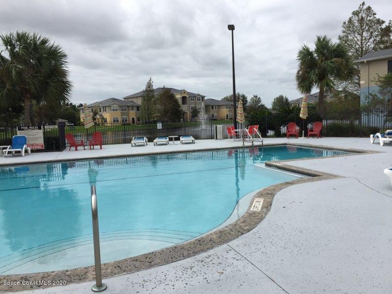 5692 Star Rush Drive, Unit 106 Melbourne, FL 32940 - Photo 15 of 16 a view of a swimming pool with a sitting space