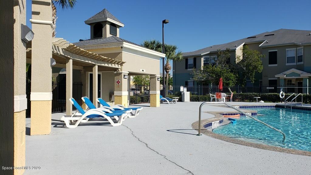 5692 Star Rush Drive, Unit 106 Melbourne, FL 32940 - Photo 16 of 16 a building outdoor space with patio furniture and potted plants