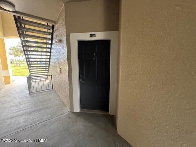 5692 Star Rush Drive, Unit 106 Melbourne, FL 32940 - Photo 2 of 16 a view of a hallway with wooden floor and a cabinet