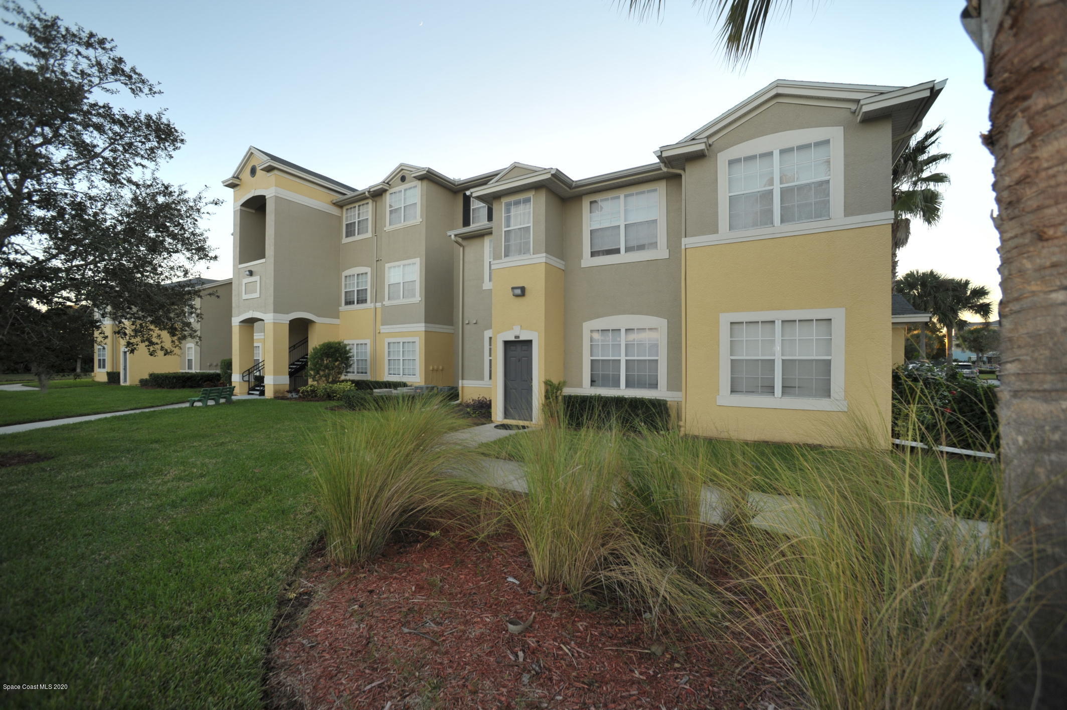 5692 Star Rush Drive, Unit 106 Melbourne, FL 32940 - Photo 3 of 16 a view of a front of house with a yard