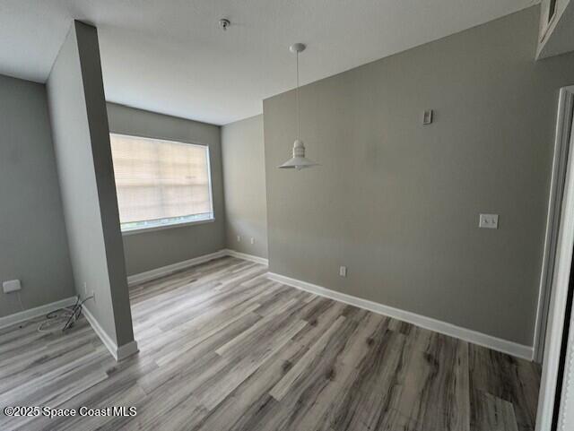 5692 Star Rush Drive, Unit 106 Melbourne, FL 32940 - Photo 6 of 16 a view of an empty room with wooden floor and a window